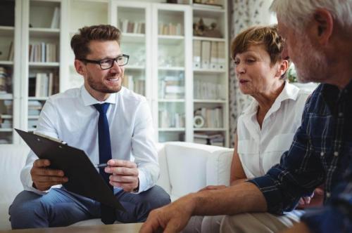 A couple discussing their retirement goals with their reverse mortgage loan officer